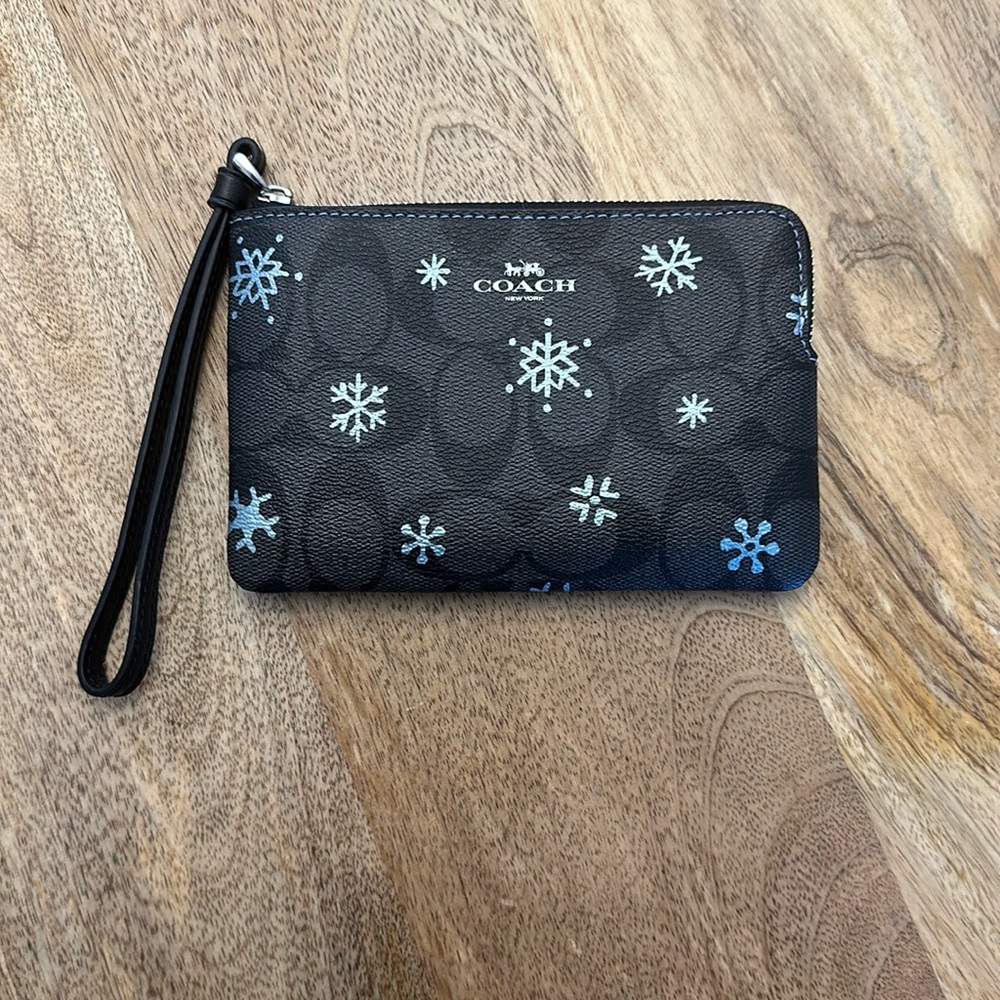 Coach wristlet, graphite leather, snowflakes in color cornflower. Never used.